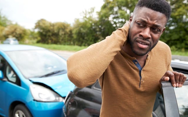 man suffering neck pain whiplash